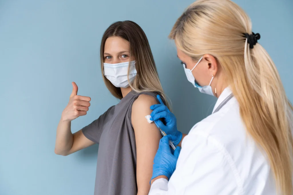 Female patient with medical mask getting vaccine