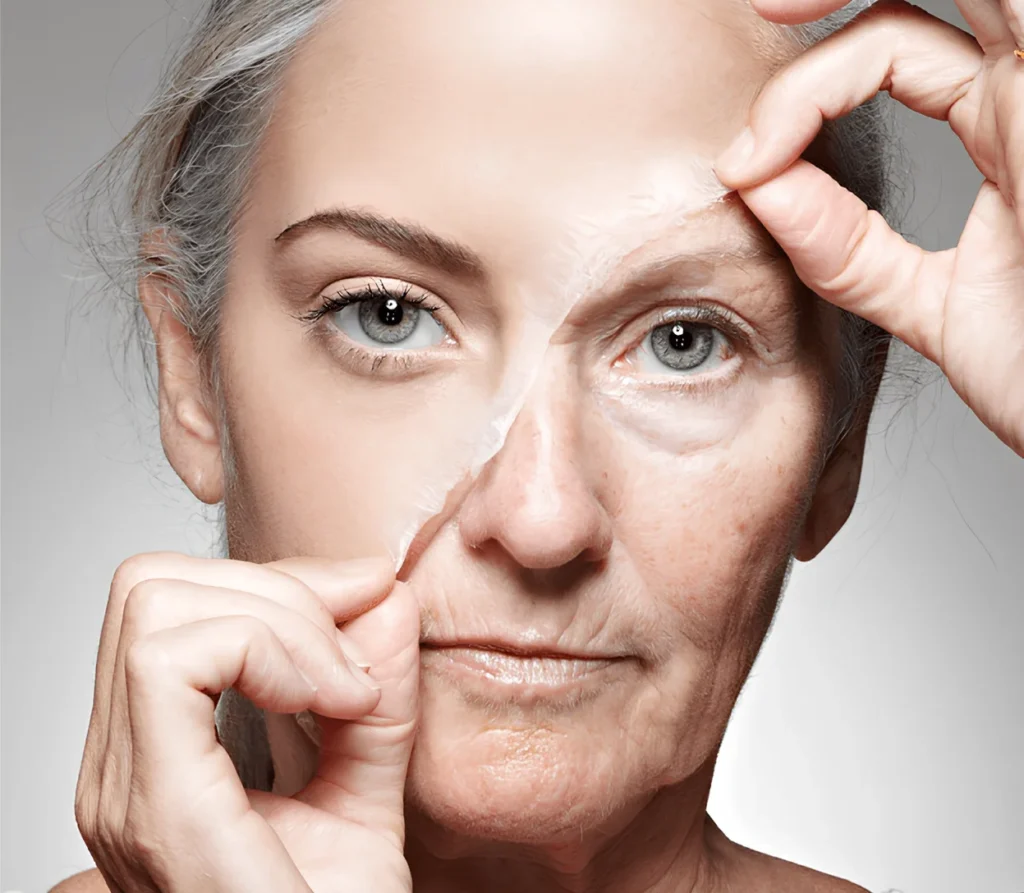 Woman peeling off a facial mask revealing half youthful skin and half aged skin concept of anti-aging skincare and skin rejuvenation.
